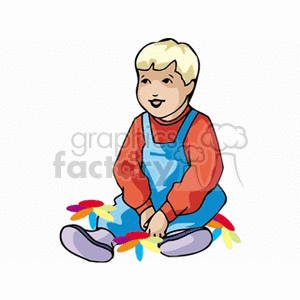 A little boy in bib overalls sitting in flowers