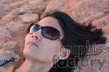 female laying on a rock