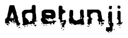 This nametag says Adetunji, and has a static looking effect at the bottom of the words. The words are in a stylized font.