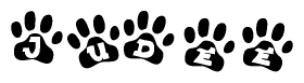 The image shows a series of animal paw prints arranged in a horizontal line. Each paw print contains a letter, and together they spell out the word Judee.
