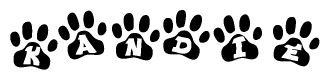 The image shows a row of animal paw prints, each containing a letter. The letters spell out the word Kandie within the paw prints.