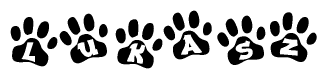 The image shows a series of animal paw prints arranged in a horizontal line. Each paw print contains a letter, and together they spell out the word Lukasz.