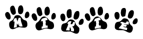 The image shows a series of animal paw prints arranged in a horizontal line. Each paw print contains a letter, and together they spell out the word Mikie.