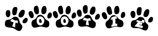 The image shows a row of animal paw prints, each containing a letter. The letters spell out the word Tootie within the paw prints.