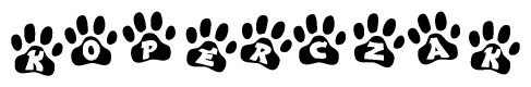 The image shows a series of animal paw prints arranged horizontally. Within each paw print, there's a letter; together they spell Koperczak
