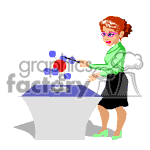 The image is a clipart showing a woman conducting a science experiment or demonstration. She has goggles on, indicating safety precautions, and is using a pipette or dropper to add a chemical to a beaker or flask that is causing a reaction, indicated by the bubbles or balls rising above the container. She is wearing a green blouse, black skirt, and green shoes, and appears to be standing in a laboratory or classroom environment.