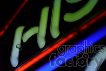 A close-up image of neon lights in green, red, and blue hues.