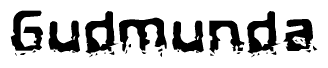 This nametag says Gudmunda, and has a static looking effect at the bottom of the words. The words are in a stylized font.