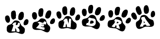 The image shows a row of animal paw prints, each containing a letter. The letters spell out the word Kendra within the paw prints.