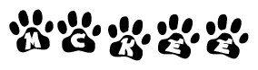 The image shows a row of animal paw prints, each containing a letter. The letters spell out the word Mckee within the paw prints.