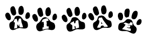 The image shows a row of animal paw prints, each containing a letter. The letters spell out the word Mihae within the paw prints.