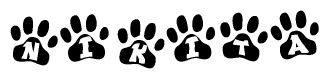 The image shows a row of animal paw prints, each containing a letter. The letters spell out the word Nikita within the paw prints.
