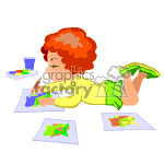   The clipart image shows a cartoon of a child with curly red hair lying on their stomach. They are focused on coloring with crayons on pieces of paper. There is a green crayon in the child