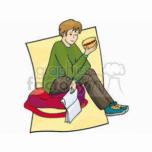 A student sitting on a cushion, holding a sandwich and a notebook, suggestive of a study break.