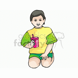 Boy dressed in green and yellow holding a sippy cup