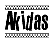 The image is a black and white clipart of the text Akidas in a bold, italicized font. The text is bordered by a dotted line on the top and bottom, and there are checkered flags positioned at both ends of the text, usually associated with racing or finishing lines.