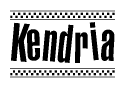 The image is a black and white clipart of the text Kendria in a bold, italicized font. The text is bordered by a dotted line on the top and bottom, and there are checkered flags positioned at both ends of the text, usually associated with racing or finishing lines.