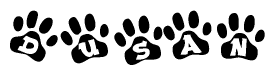 The image shows a series of animal paw prints arranged in a horizontal line. Each paw print contains a letter, and together they spell out the word Dusan.