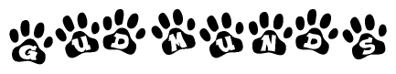 The image shows a series of animal paw prints arranged horizontally. Within each paw print, there's a letter; together they spell Gudmunds