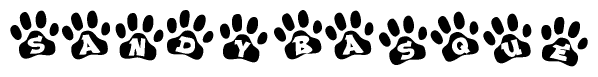 The image shows a series of animal paw prints arranged in a horizontal line. Each paw print contains a letter, and together they spell out the word Sandybasque.