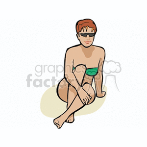 Red haired woman at the beach in a green bathing suit