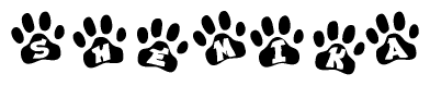 The image shows a row of animal paw prints, each containing a letter. The letters spell out the word Shemika within the paw prints.