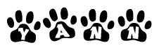 The image shows a row of animal paw prints, each containing a letter. The letters spell out the word Yann within the paw prints.