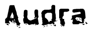 This nametag says Audra, and has a static looking effect at the bottom of the words. The words are in a stylized font.