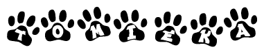 The image shows a series of animal paw prints arranged in a horizontal line. Each paw print contains a letter, and together they spell out the word Tomieka.