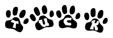 The image shows a series of animal paw prints arranged in a horizontal line. Each paw print contains a letter, and together they spell out the word Tuck.