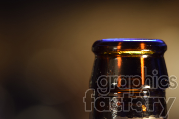 Close-up view of a beer bottle neck and cap with blurred background.