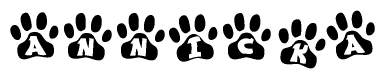 The image shows a series of animal paw prints arranged in a horizontal line. Each paw print contains a letter, and together they spell out the word Annicka.