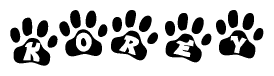 The image shows a series of animal paw prints arranged in a horizontal line. Each paw print contains a letter, and together they spell out the word Korey.