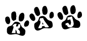 The image shows a row of animal paw prints, each containing a letter. The letters spell out the word Kaj within the paw prints.