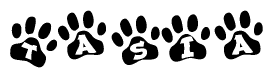 The image shows a series of animal paw prints arranged in a horizontal line. Each paw print contains a letter, and together they spell out the word Tasia.