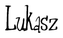 The image is a stylized text or script that reads 'Lukasz' in a cursive or calligraphic font.