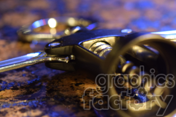 Close-up image of a corkscrew and bottle opener on a blurred background.