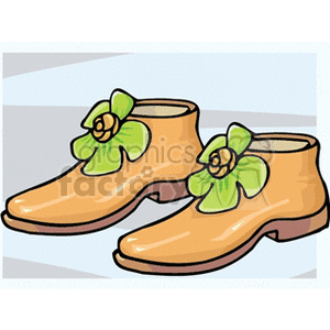 A pair of orange shoes with green flower decorations.