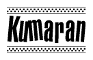 The image contains the text Kumaran in a bold, stylized font, with a checkered flag pattern bordering the top and bottom of the text.