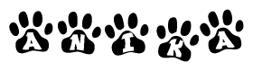 The image shows a series of animal paw prints arranged in a horizontal line. Each paw print contains a letter, and together they spell out the word Anika.