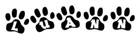 The image shows a series of animal paw prints arranged horizontally. Within each paw print, there's a letter; together they spell Luann