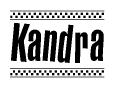 The image is a black and white clipart of the text Kandra in a bold, italicized font. The text is bordered by a dotted line on the top and bottom, and there are checkered flags positioned at both ends of the text, usually associated with racing or finishing lines.