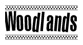 The clipart image displays the text Woodlands in a bold, stylized font. It is enclosed in a rectangular border with a checkerboard pattern running below and above the text, similar to a finish line in racing. 