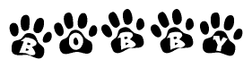 The image shows a series of animal paw prints arranged in a horizontal line. Each paw print contains a letter, and together they spell out the word Bobby.