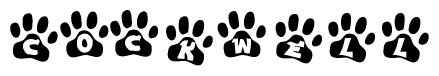 The image shows a row of animal paw prints, each containing a letter. The letters spell out the word Cockwell within the paw prints.