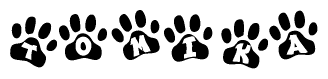 The image shows a series of animal paw prints arranged in a horizontal line. Each paw print contains a letter, and together they spell out the word Tomika.