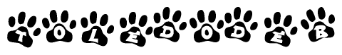 The image shows a series of animal paw prints arranged horizontally. Within each paw print, there's a letter; together they spell Toledodeb