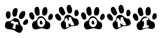 The image shows a series of animal paw prints arranged in a horizontal line. Each paw print contains a letter, and together they spell out the word Tomomi.