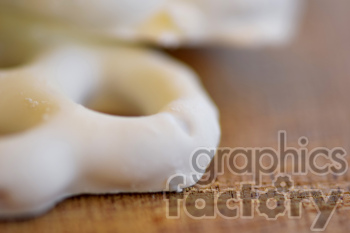 Close-up of a white icing-covered pretzel.