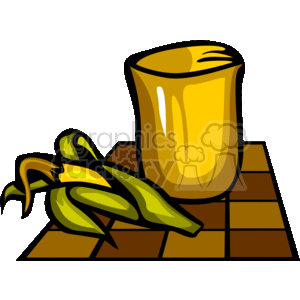 The clipart image features a yellow cup or goblet alongside what appears to be two ears of corn resting on top of a brown, woven mat which may be indicative of a traditional African mat used during Kwanzaa celebrations.